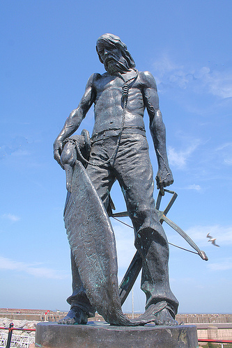 The Mariner with albatross about his neck and crossbow in his hand.